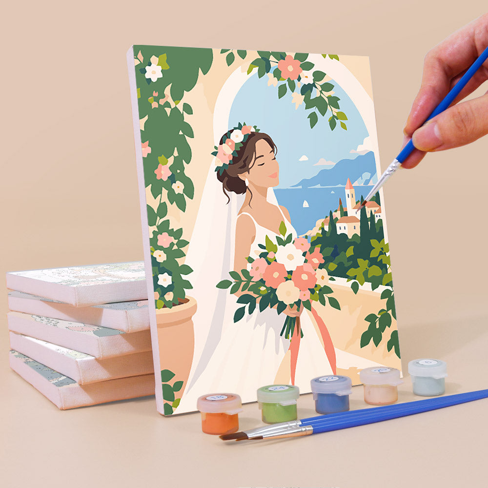 Painting a Wedding Day mini canvas propped up beside numbered acrylic paints