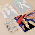 Painting one of the Wide-Brim Glamour designs next to a stack of mini canvases