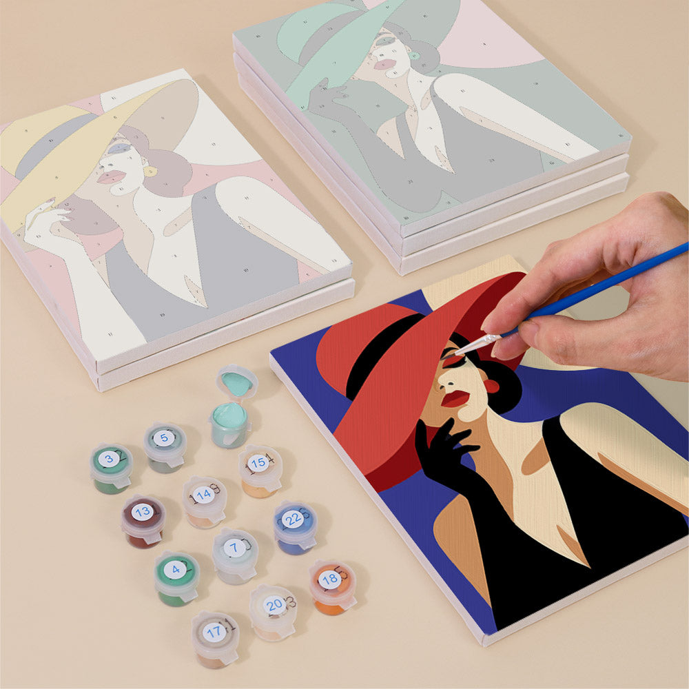 Painting one of the Wide-Brim Glamour designs next to a stack of mini canvases