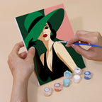 Hand holding a Wide-Brim Glamour mini canvas while painting the details