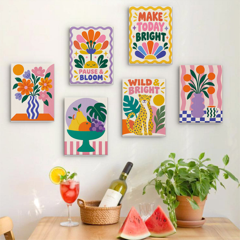 Six finished Wild & Bright mini paintings hung on a wall above a table