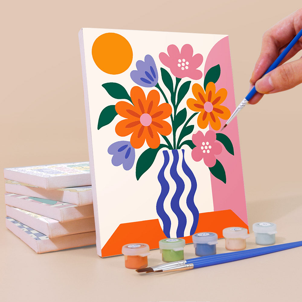 Painting a Wild & Bright mini canvas propped up beside numbered acrylic paints