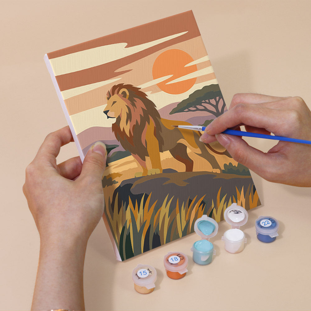 Hand holding a Wild Waterholes mini canvas while painting the details