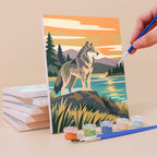 Painting a Wild Waterholes mini canvas propped up beside numbered acrylic paints