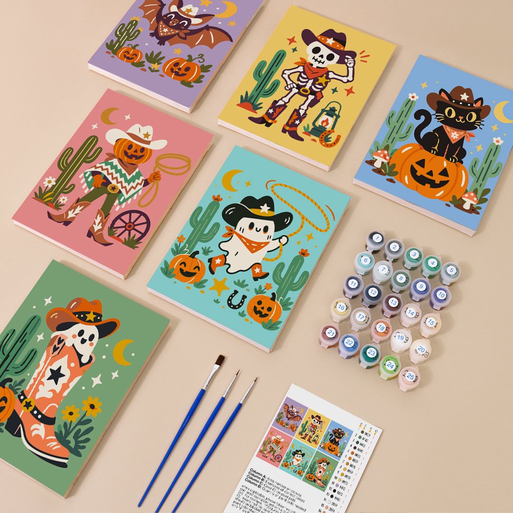 Painting one of the Wild West Halloween designs next to a stack of mini canvases