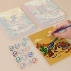 Painting one of the Wild West Nights designs next to a stack of mini canvases