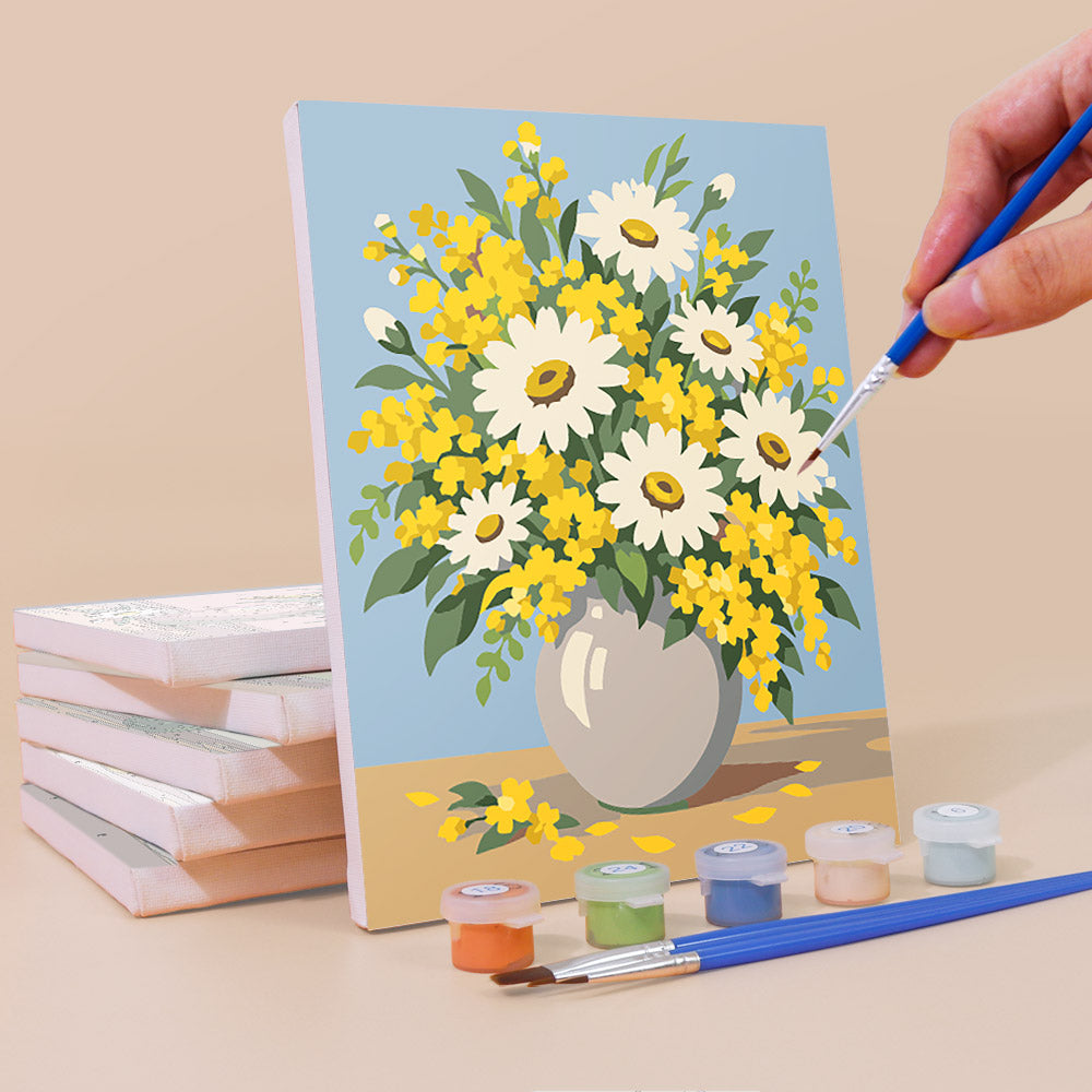 Painting a Wildflower Vases mini canvas propped up beside numbered acrylic paints