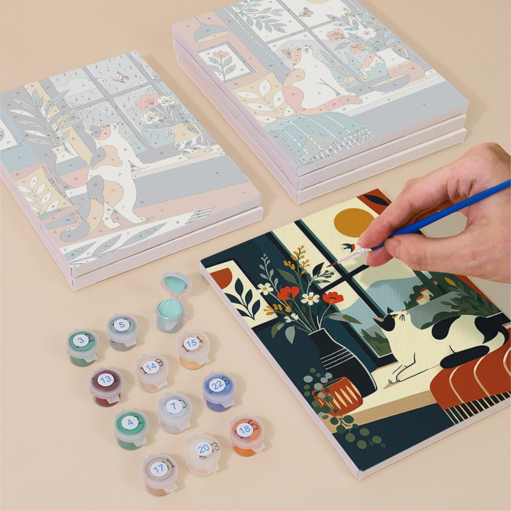 Painting one of the Window Cats designs next to a stack of mini canvases