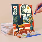 Painting a Window Cats mini canvas propped up beside numbered acrylic paints