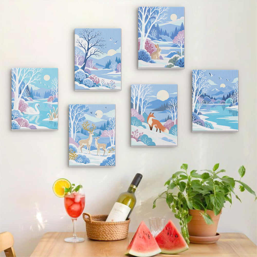 Six finished Winter Wonderland mini paintings hung on a wall above a table