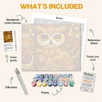 What's included in the Wisdom of Gold paint by numbers kit: numbered linen canvas, reference sheet, color guide, 24 acrylic paints, 3 brushes and thank you card