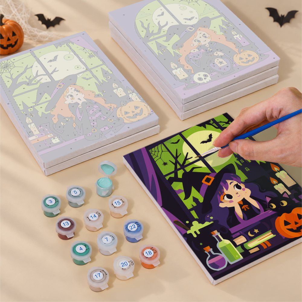Painting one of the Witching Windows designs next to a stack of mini canvases