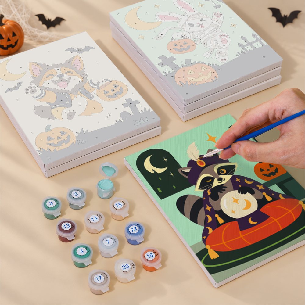 Painting one of the Woodland Costume Party designs next to a stack of mini canvases