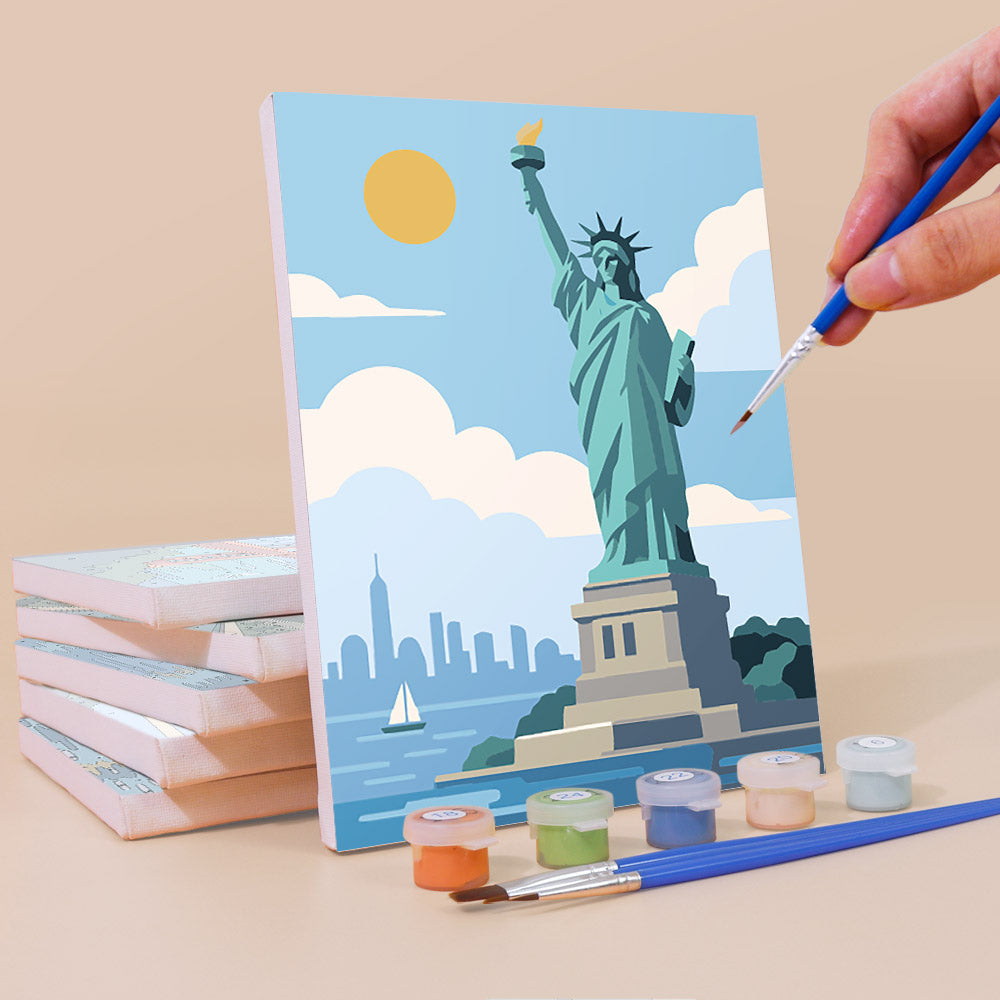 Painting a World Landmarks mini canvas propped up beside numbered acrylic paints