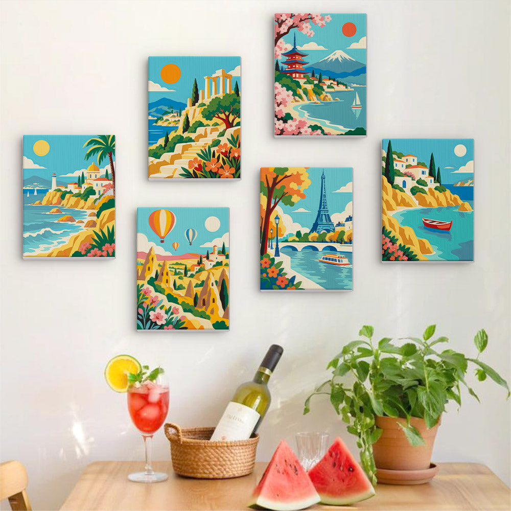 Six finished World Wanderer mini paintings hung on a wall above a table