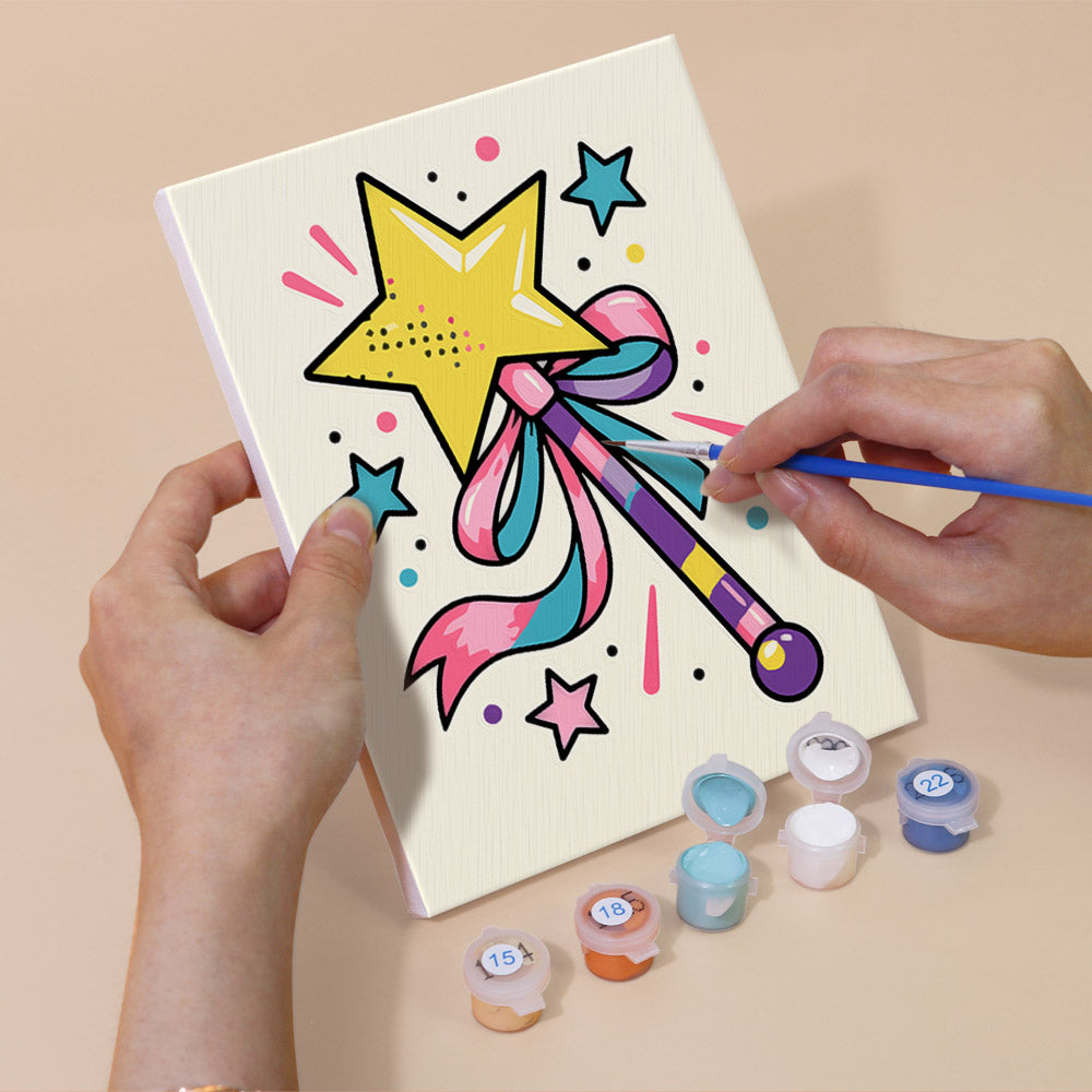 Hand holding a Y2K Doodles mini canvas while painting the details