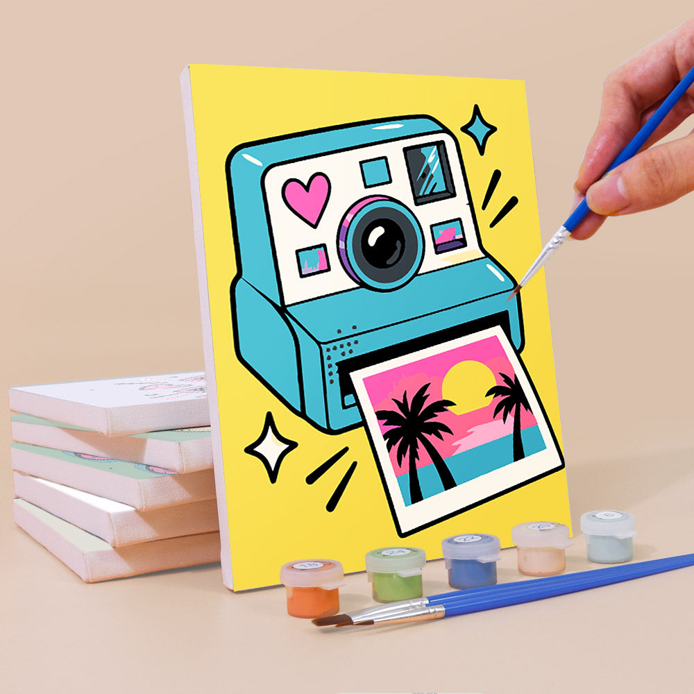 Painting a Y2K Doodles mini canvas propped up beside numbered acrylic paints
